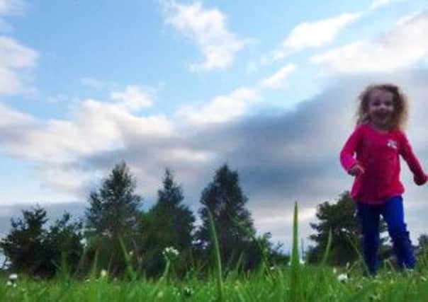 Megan Rosss photo of her younger sister running in the garden of their home in Cullybackey has been named as a winner in the annual One Summers Day photography competition.