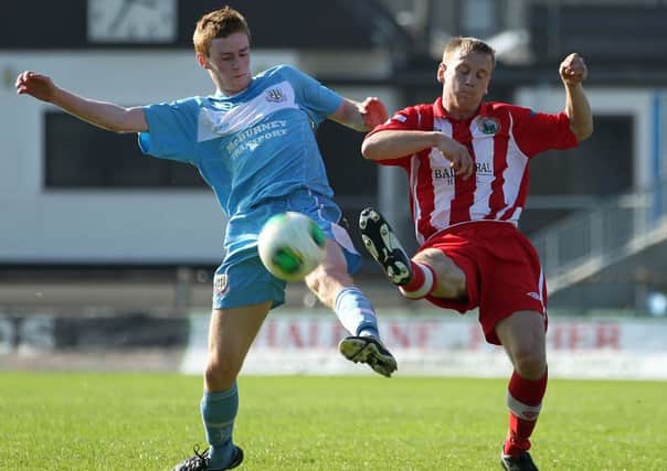 Ballymena United  Aaron Stewart tussles for possession with Warrenpoint Town's Liam Bagnall during today's Danske Bank Premiership match at Ballymena Showgrounds. Picture: Press Eye.