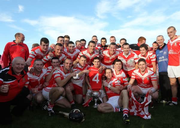 CUP OF JOY ...  Antrim Senior Hurling Championship winners Loughgiel celebrate their win over Cushendall in the Antrim final in Ballycastle. Picture by John McIlwaine/Presseye.com