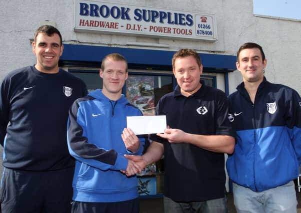 Stuart McDonald, Jason Stewart and Paul McBurney of Ahoghill Thistle, are pictured receiving sponsorship from Darren Logan of Brook Supplies. INBT40-239AC