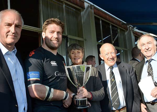 Ballymena captain Brian Young receives the Des Dempsey trophy fromJohnny Moffett and his wife Christine as looking on are Guy McCullough and John Gaffney (Galwegians). INBT40-243AC