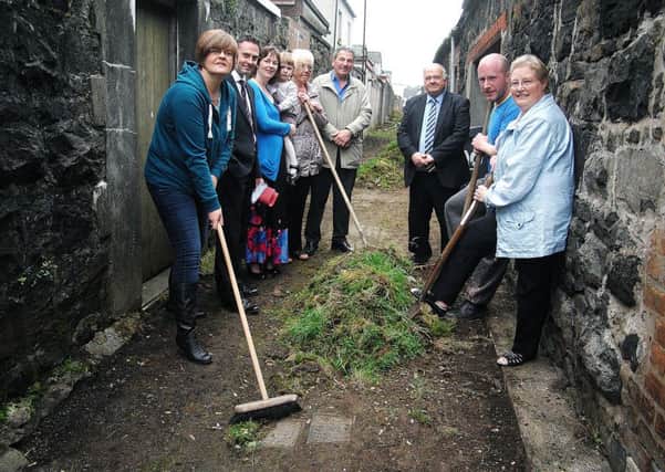 Ballymena Councillors Paul Frew, MLA; and Martin Clarke photographed with Louise Thompson (Chair-person), Mae Black (vice-chair) and members of the Smithfield and Area Association cleaning up an area of Clarence Street. INBT 40-806H