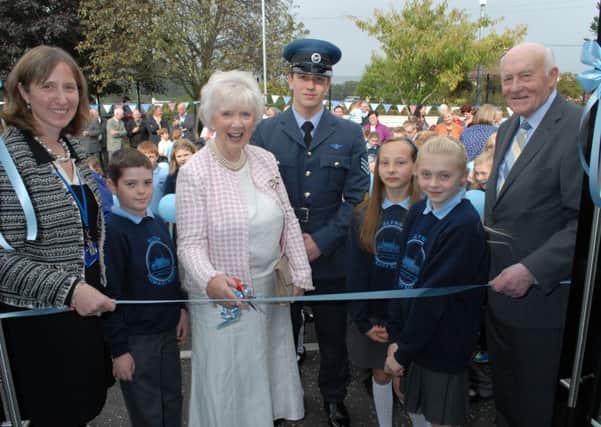 Joan Christie OBE cuts the ribbon to officially re-open Glynn Primary School. With her are Principal Miss Diane Hawthorne, pupils Robbie, Claire and Georgia, Lord Lieutenant's Cadet Ben Smith and Alderman Roy Beggs. INLT 40-353-PR