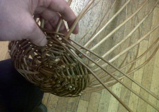 Whaling the bottom of a willow basket...