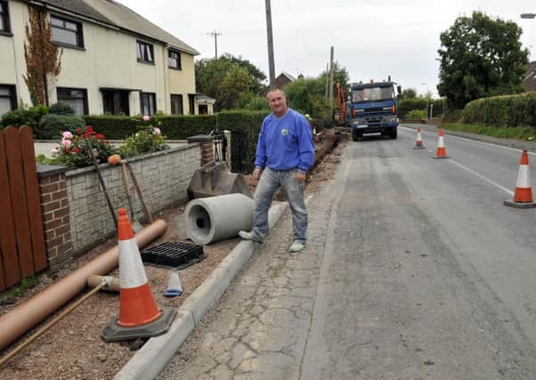 Cllr Declan McAlinden welcomes the work being carried out at Wolf Island Terrace. INLM40-121gc