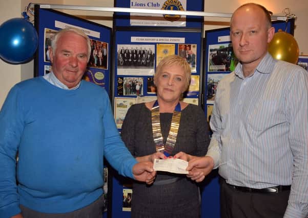 Matt Hill and Ian Duff of the Shane Castle Steam Group, are pictured presenting a cheque for £2,000 to Anne Henry, President of Ballymena Lions Club. The money was raised at the Shane Castle May Day Steam Engine Rally and will be use for Lions Club Charity funds. INBT40-220AC