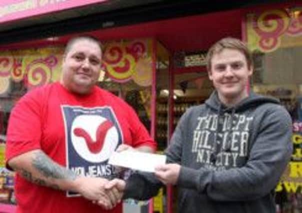 SWEET SPONSOR. Mark Steen (right) of the Candy Store Ballymoney, pictured on Wednesday presenting a sponsored cheque to Marcus Boreland, committee member of Glebe Rangers FC. The Club would like to take this opportunity to sincerely thank all sponsors for their continued support which is greatly appreciated by all connected with the club.INBM40-13 013SC.