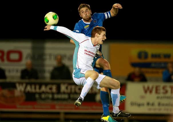 Ballymena United's Aaron Stewart competes for a high ball with Ballinamallard skipper Mark Stafford during Friday night's match at Ferney Park. Picture: Press Eye.