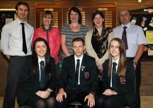 Emma McGrath (joint first place Child Development), Aaron Henry (11 A*'s in GCSE, and second place in both Geography and Physics) and Elizabeth Adair (joint third Business studies), from Cambridge House Grammar School who were top achievers in Northern Ireland for GCSE. They are pictured with their teachers Mr. M. Best, Mrs. J. Bradley, Mrs. C. Wallace, Mrs. A. Proctor and Mr. D. Shannon. INBT41-225AC