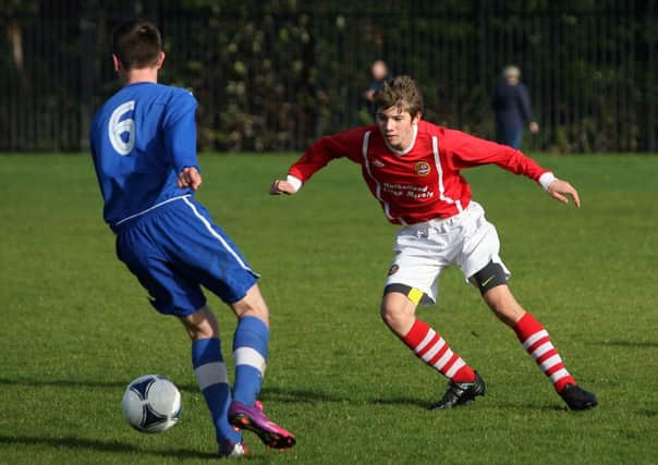 Carniny U-16 player Thomas Johnston tries to stop the attack of his Ballymoney opponent. INBT41-241AC