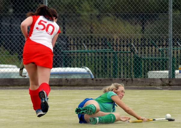 Ballymena's Lauren Kennedy slips as she defends the ball from a Larne attack. INBT41-266AC