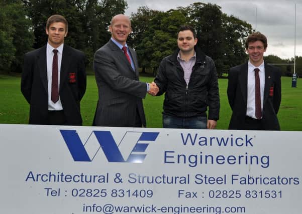 Mr David Warwick, of Warwick Engineering, presents a sponsorship cheque for senior rugby at Ballymena Academy to Mr Alistair McKay. Also included are players Dean Reynolds and Craig Hanna.