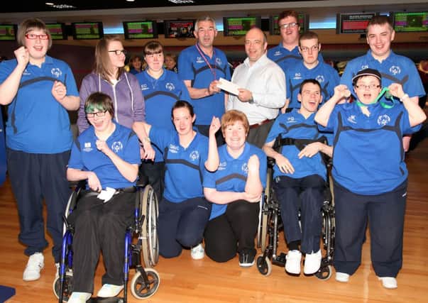 Dougie Fillis, head coach, and members of the Jet Set Special Olympics Club pictured presenting a donation cheque to Tony Murray, chairperson of the Coleraine Cougars Special Olympics Club. INCR24-404PL