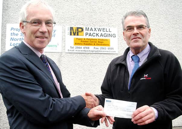 John Maxwell, Maxwell Packaging, presents a sponsorship cheque to Richard Wilson of Ballymena Road Club. INBT 40-823H