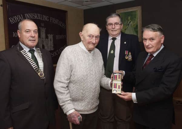 Sir Donal Keegan, Lord Lieutenant for the City of Londonderry, handing over the award to Fred Cappendale during a recent ceremony in the Services Club. Included are George Black, left, Northern Ireland Chairman of the Royal British Legion, and Jim Thompson, who was also presented with a medal for his service in Singapore from 1964 to 1967. INLS4113-101KM