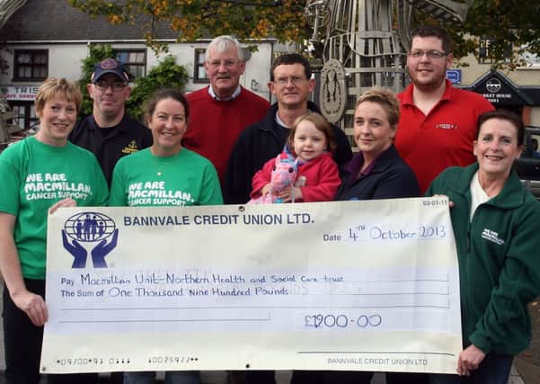 Michelle Ferguson (far right), on behalf of Macmillan Unit, receives a cheque for £1900 from Francis Dobbin, Brian Mooney (Community Rescue Service), Louise Morrison (Rose Cafe), Sean McGarry (Gig n the Bann), Martin Kearney (Gig n the Bann), Steven Clarke (Steve's Take Away), Grace Donaghy (Bannvale Credit Union) and young Gracie Donaghy, money raised from the Gig n the Bann annual fun run. INBT41-231AC