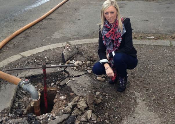 Councillor Carla Lockhart at a fire hydrant in Waringstown
