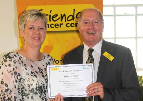 Kay Smith, Volunteer Complementary Therapist with Focus on Family, Ballysally, Coleraine is pictured receiving her certificate from Gordon McKeown, Chairman of Friends of the Cancer Centre. INCR42-106S