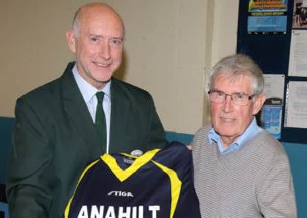 Arnold Morgan, chairman of Ulster Table Tennis, presents Josh Toombs, founder member of Anahilt Table Tennis Club, with a specially designed shirt to mark the club's 60th anniversary. US1340-529cd