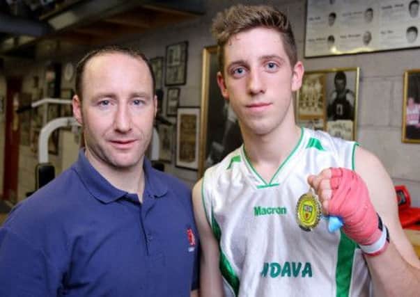 Martin Laverty, head coach at Lisburn Boxing Club, with Arturs Sterns. medal winner at the County Antrim intermediates - his third championship win at the event.  US1340-527cd