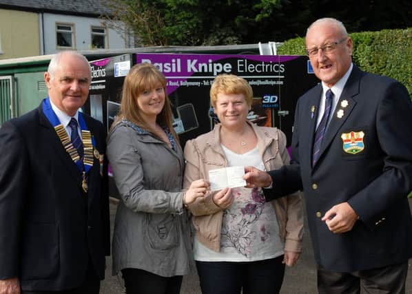 Sheena and Barbara Brewster receive a cheque for £1500 on behalf of Friends of the Cancer Centre, Belfast from Jim Duncan as President Sam McArthur watches on.