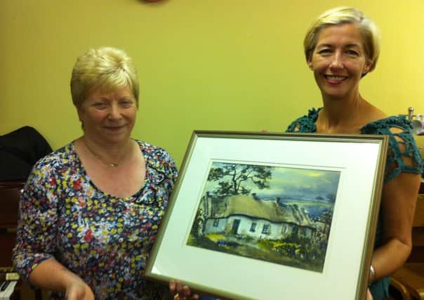 Tracey McIlwaine, WI executive member, presents the Briggs picture to Isobel Clark INLT 42-652-CON