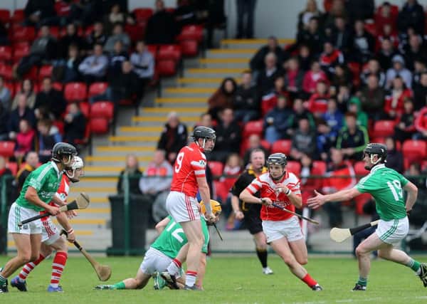 Loughgiel's Tony McCloskey steps aside as team-mate  Mark McFadden finds a gap as he clears up the danger during Sunday's Ulster Club Senior Hurling Championship semi-final at Owenbeg.