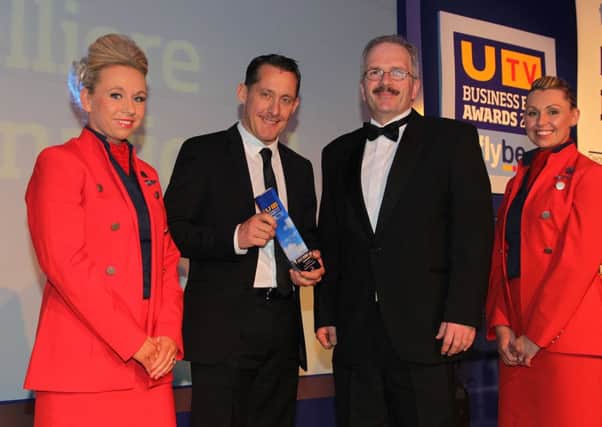 Receiving the award is Chris Lomas, Sales Director of Xpelgum with Sam Kingham Sector Manager of R&D category sponsors Invest NI and Flybe cabin crew members Kara Doherty and Victoria Montgomery.