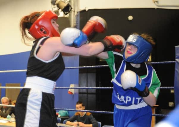Rachel Tweels, St Jospeh's ABC, lands a right jab on Shannon Ownes, Gilford boxing club.