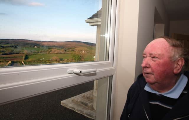 ROOM WITH A VIEW. Eamon McBride, pictured looking out at the view from his front room which he feels will be blighted with more windmills.INBM21-12 014SC.