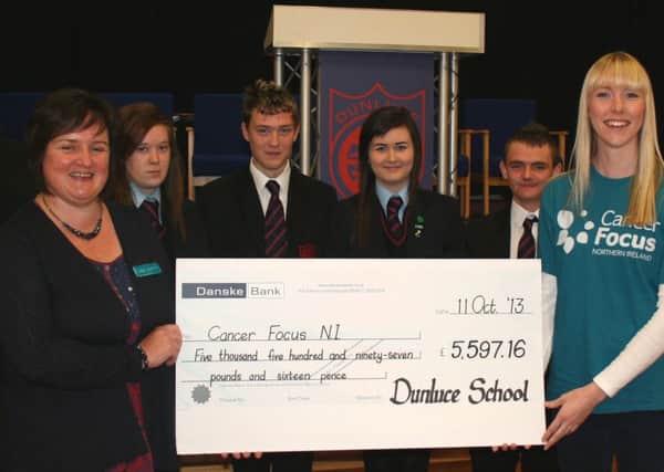 Pictured along with the Principal Mr. P. Smyth, is Vice-Principal Mrs. E. McIlveen, Maeve Colgan and Valerie McGowan receiving the cheque and this years top fundraisers from each Year Group: Shannon McLaughlin, Sandy Kane, Leah Elliott and Kyle McLelland. INCR43-114s
