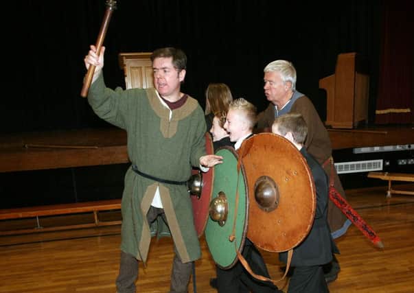 Ralph Adams and Adam Sneddon, with Living History, pictured with pupils from Cullybackey High school during a reinaction of the Battle of Hastings. INBT42-211AC