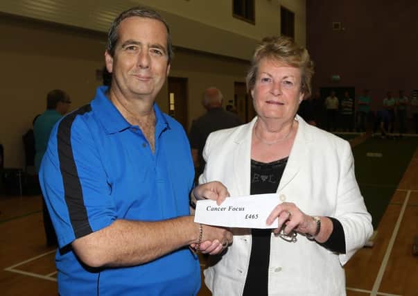 Bryan Magrath presents a cheque to Betty Millar of Ballymena Cancer Focus at last week's final of the Bryan Magrath Charity Shield at 1st Ahoghill.