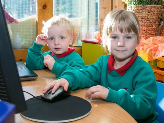 Ryan Reid and Sophie Whiteside working together on the computer at Ashgrove Nursery. INNNT 42-402-RM