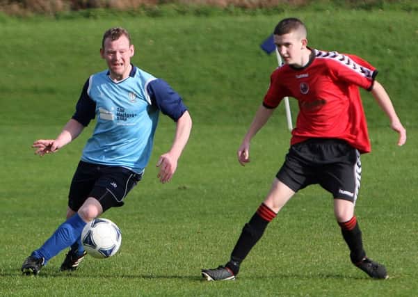 Leslie McCaughran (Seven Towers FC) passes the ball past Lee McDowell (Randalstown) during their match at Ballymena Showgrounds last week. INAT43-413AC