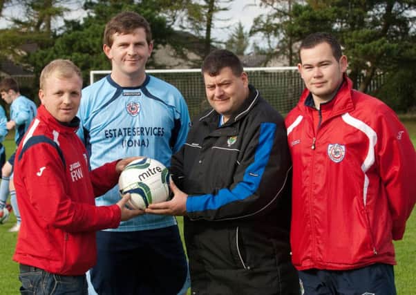 Ian Doherty, second from right, of Jet One Boilers, pictured handing over a sponsored match ball to, from left, Roy Watson, Stuart Moore and Johnny Doherty, of Irish Street Football Club, for their Irish Junior cup match against Dromore Amateurs FC on Saturday. INLS4313-101KM