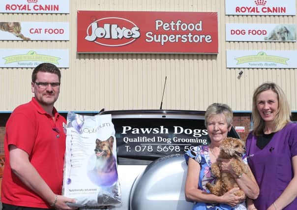 Jolleys Assistant Manager Gary Dornan with Maureen McKinney and her dog Tammy with Helen from Pawsh Dogs. INBT 36-102JC