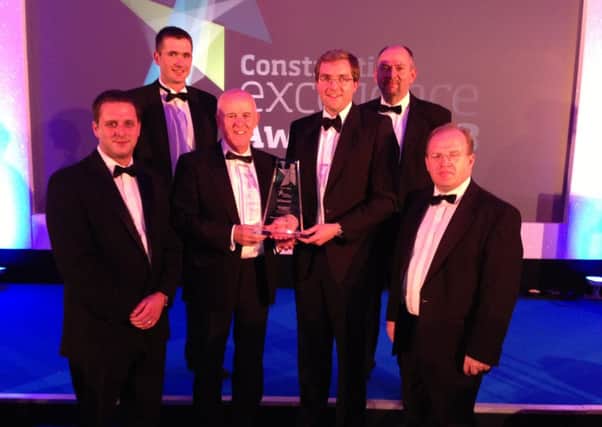 Key industry personnel from McLaughlin & Harvey, including partners Translink, Doran Consulting and M. Hasson & Son step up to receive the top award in the Transport Infrastructure section for the Ballymoney Railway Bridge at the prestigious CEF Construction Excellence Awards 2013. INBM43-13