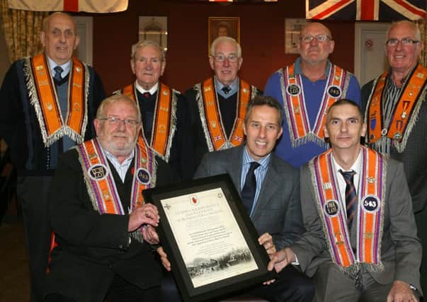 Ian Paisley MP presents a special certificate to Worshipful Master Sam Beattie and Deputy Master David Brown and members of Cromkill Lodge, marking the signing of the Ulster Covenant during Ulster Day, 28 September 1912, in the local hall. The certificates were presented on behalf of the Ulster Scots Agency and will be presented to every hall where the covenant was signed. INBT43-215AC