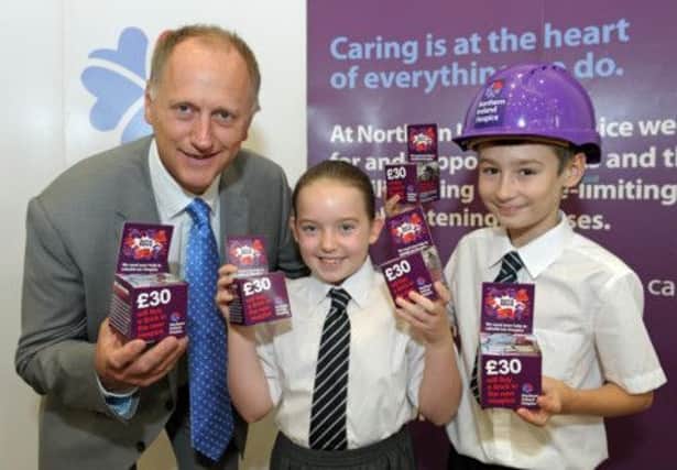 Mossley Primary School pupils Jodie McCarde and Kurtis Kirkland join principal Stephen Mulligan at the launch of the Wall of Hope appeal for Northern Ireland Hospice. INNT 43-506CON Pic by Simon Graham, Harrisons