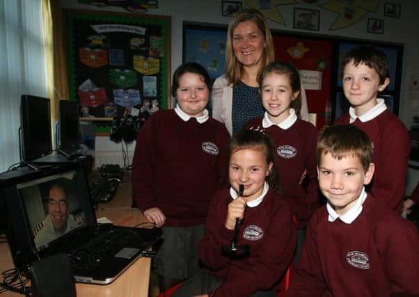 Diamond PS pupils Anna Finton, Joshua Stewart, Sarah Gilmore, Emma Milligan and Calum with teacher Mrs. J. Stewart, during their Skype session with pilot Bryan Pill from Mission Aviation Fellowship, as part of the class theme Up, Up and Away. INBT42-205AC