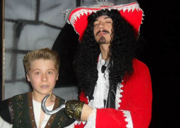 Dylan Breen as Peter Pan and Ethan Haddock as Captain Hook.
