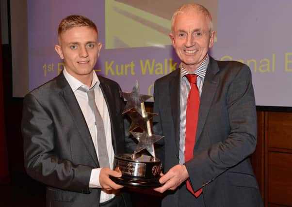 Michael Drayne from event sponsor Draynes Farm, presents the Senior Sports Personality of the Year to Kurt Walker from Canal Boxing Academy.