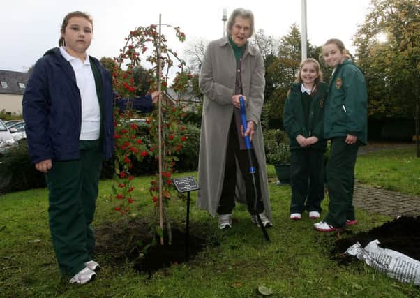Lady Moyra Campbell plants a tree, originally planted by the Prince of Wales and Duchess of Cornwall, in the grounds of Gracehill PS, assisted by pupils Carla Neeson, Louise Surgenor and Kacey Lackermeier. INBT43-267AC