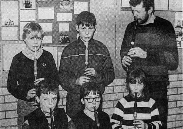 1985 - Stephen Reynolds of the Seven Towers Pipe Band gives instruction to pipers at their beginners class in Ballee High Schoool. Back row from left: Mark Ballentine and David Holden. Front row: Colin Torrington, Brian Reynolds and Jayne Murray. INBT42-760F