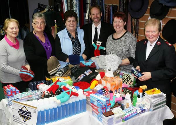 Colin Jenkins, of the Seamen's Christian Friend Society, is pictured with Chris Torrington, Thelma Irwin, Yvonne Wylie, Doreen Armstrong (Salvation Army Shop) and Elizabeth Pritchard (Salvation Army), with goods collected by the Knitting Group and members of the Salvation Army, that Colin will take with him to Cork. INBT43-269AC