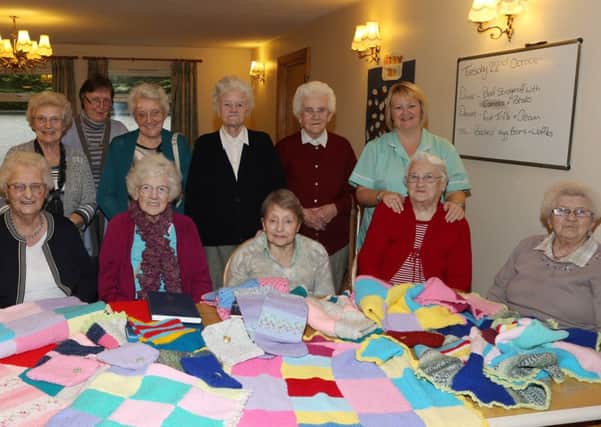 Residents of Andena Residential Home who knitted blankets for the Presbyterian Church in Ireland Overseas charity are seen here with volunteers Pearl Laverty (back left) and Jean Kerr (3rd from right) who sewed them together and Rae Dunlop (2nd left) from PCI. Included are Lily Dunseith, Pat Allan, Elizabeth Crawford, Miriam Marcus, Margaret Wendrum, Mary Reid and Georgie Allan, plus Andena Activity Co-ordinator Valerie Guthrie. INBT 44-110JC
