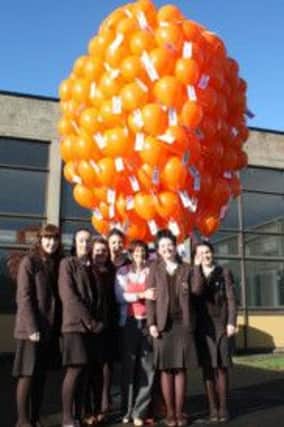 HELPING OUT. Mrs Magee and 6th form pupils who helped with the fund raising.INBM44-13 9002F