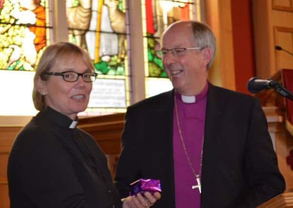 Bishop Ken Good presents Bishop-Elect Pat Storey with her Episcopal Ring.