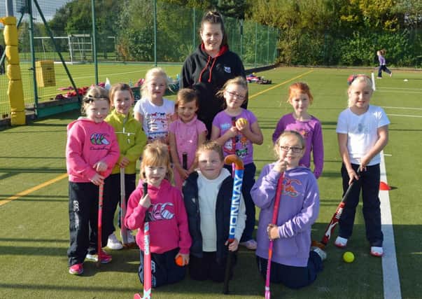 Primary Three schoolchildren pictured with coach Morgan Burke at the Mini Hockey session in the Town Park. INLT 42-006-PSB